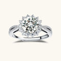 Close-up of sterling silver halo ring with brilliant round moissanite center stone surrounded by smaller accent stones
