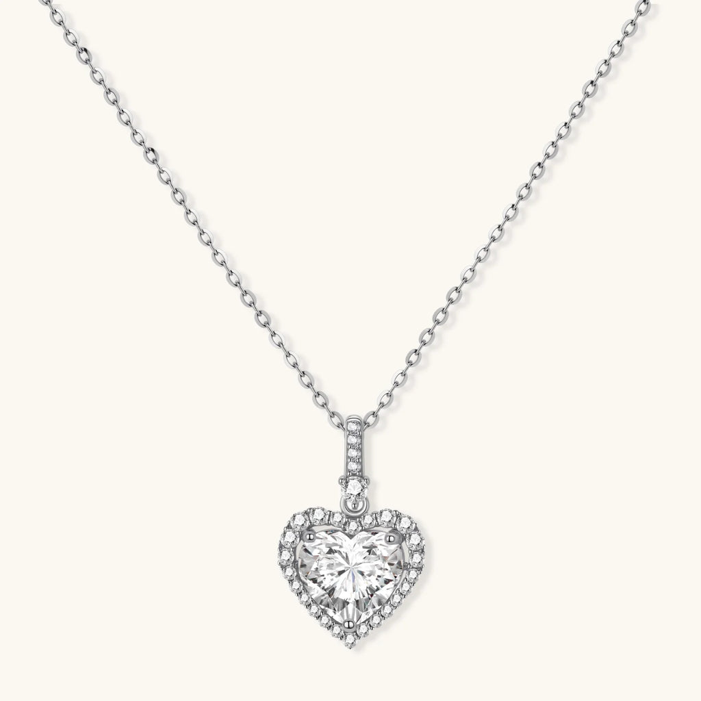 Complete jewelry set with heart-shaped sterling silver pieces featuring brilliant moissanite stones on white background.