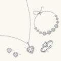 Complete jewelry set with heart-shaped sterling silver pieces featuring brilliant moissanite stones on white background.