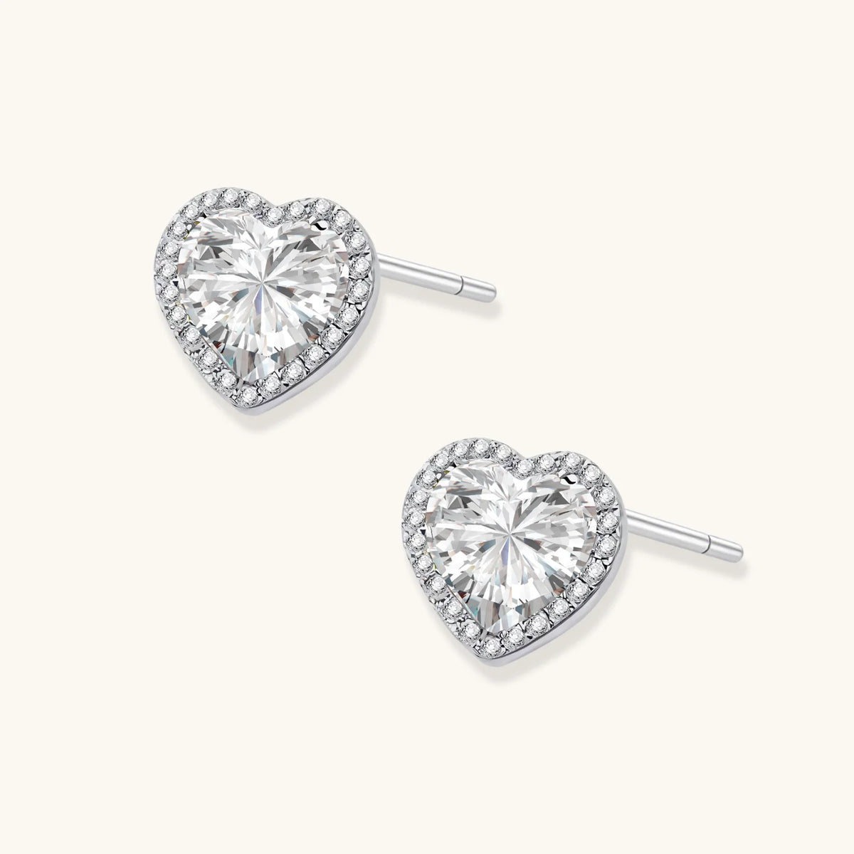 Complete jewelry set with heart-shaped sterling silver pieces featuring brilliant moissanite stones on white background.