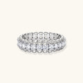 Sterling silver eternity ring with continuous row of brilliant moissanite stones in scalloped crown setting with milgrain detail