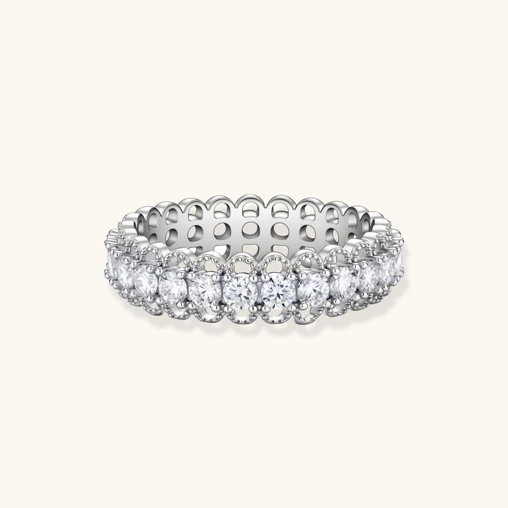 Sterling silver eternity ring with continuous row of brilliant moissanite stones in scalloped crown setting with milgrain detail