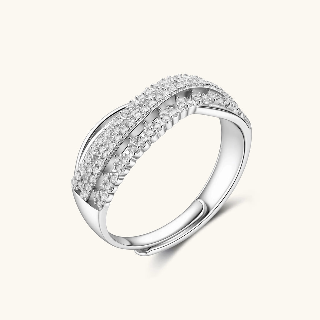 Sterling silver crossover ring with pavé-set moissanite stones creating an elegant infinity design on neutral background