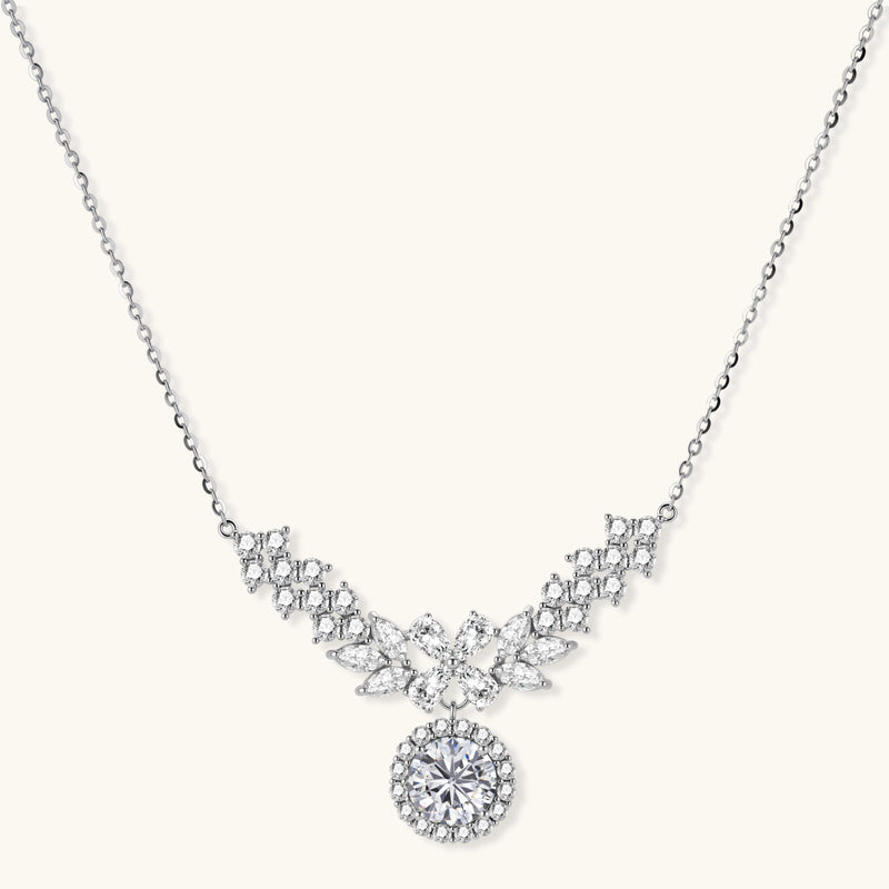 Elegant sterling silver necklace featuring intricate wing-like design with brilliant moissanite stones on neutral background.