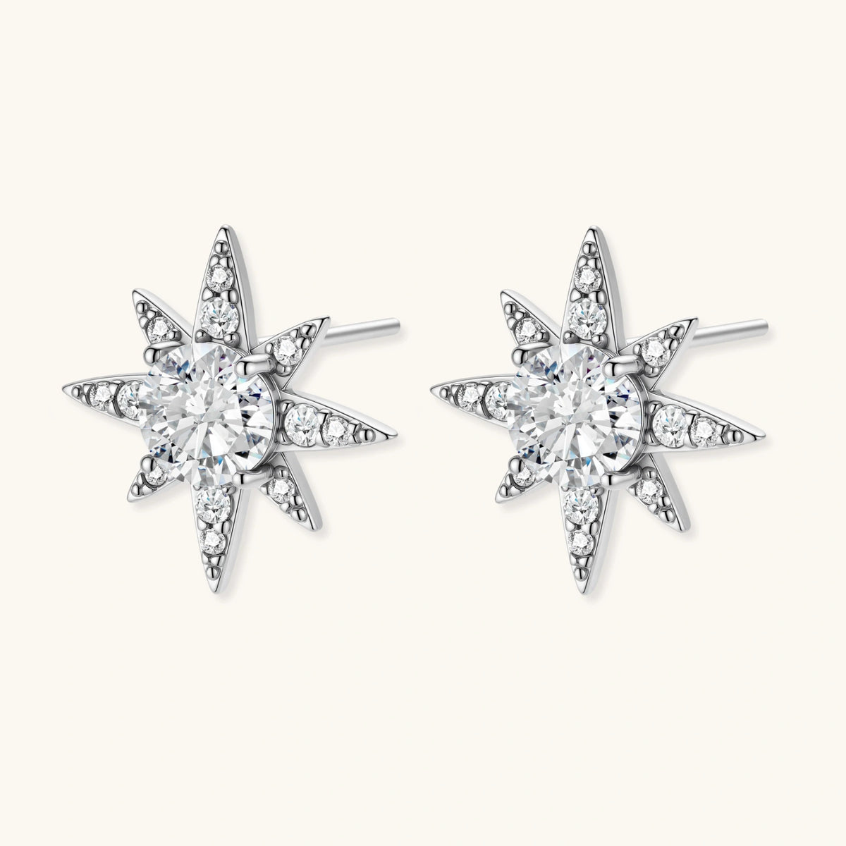 Sterling silver star-shaped stud earrings with brilliant moissanite center stones and pavé details on neutral background.
