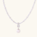 Dainty necklace with lavender crystal beads, freshwater pearls, geometric pendant, and large pearl drop on white background.