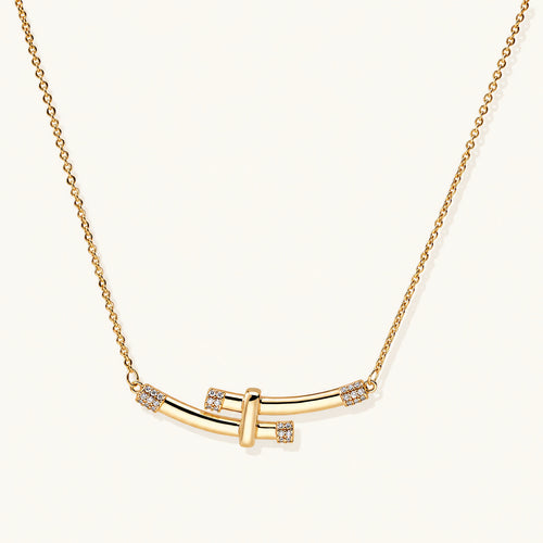 Gold-plated curved bar necklace with diamond accents on delicate chain against cream background