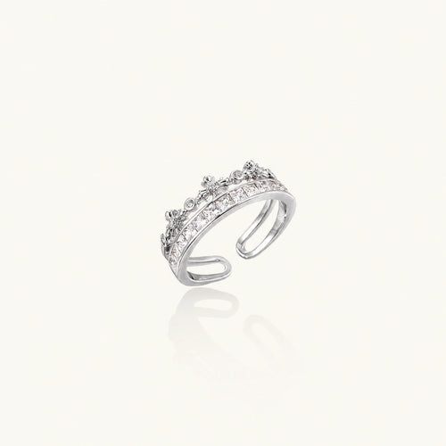 Silver-toned adjustable crown ring with channel-set square zirconia stones and delicate floral details on white background
